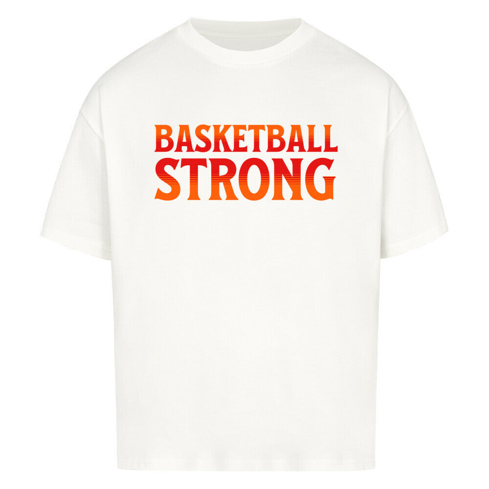 Weißes Oversized Basketball T-Shirt mit dem Print „BASKETBALL STRONG“ in einer ikonischen, rot-orangen Retro-Schriftart. Aus 100% Baumwolle.