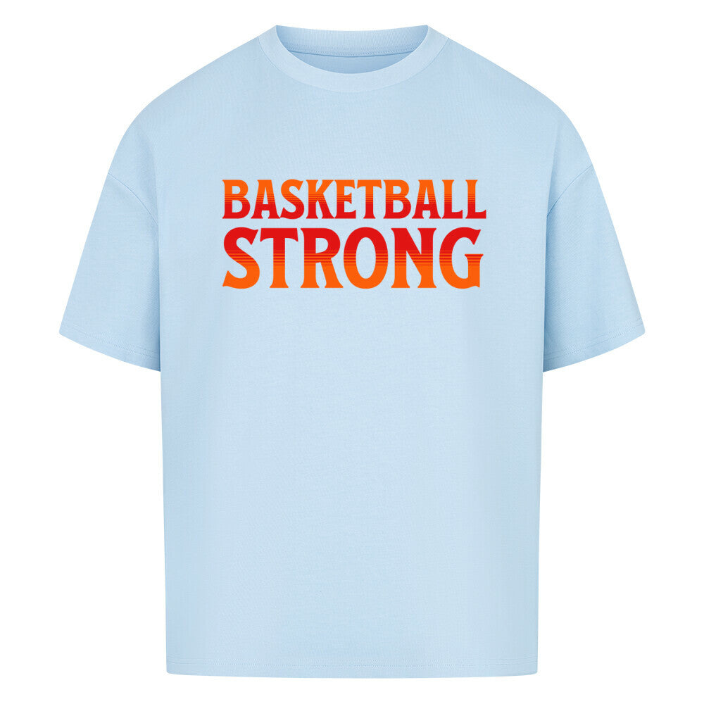Babyblaues Oversized Basketball T-Shirt mit dem Print „BASKETBALL STRONG“ in einer ikonischen, rot-orangen Retro-Schriftart. Aus 100% Baumwolle.