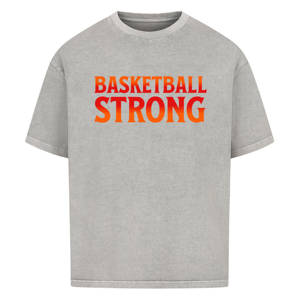 Washed Grey Oversized Basketball T-Shirt mit dem Print „BASKETBALL STRONG“ in einer ikonischen, rot-orangen Retro-Schriftart. Aus 100% Baumwolle.