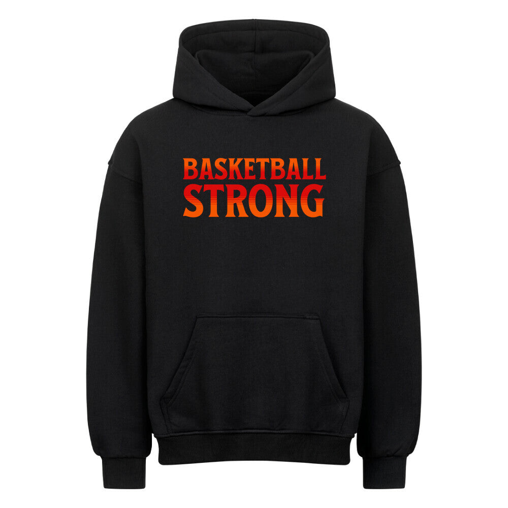 Vorderansicht eines schwarzen Oversized-Hoodies mit dem Aufdruck 'BASKETBALL STRONG' in einer rot-orangen Farbverlaufsschrift auf der Brust. 80% Baumwolle 20% Polyester.