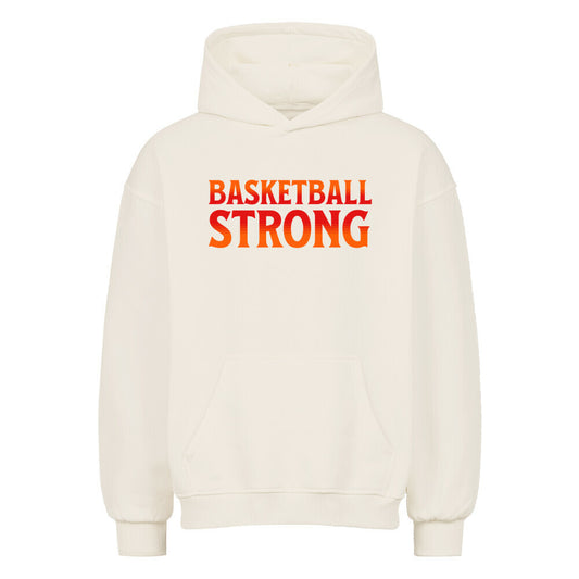 Vorderansicht eines cremefarbenen Oversized-Hoodies mit dem Aufdruck 'BASKETBALL STRONG' in einer rot-orangen Farbverlaufsschrift auf der Brust. 80% Baumwolle 20% Polyester.