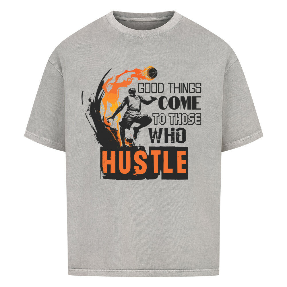 Washed Grey Oversized T-Shirt mit einem schwarz-orangen Print eines Basketballspielers in Flammen und dem motivierenden Spruch „GOOD THINGS COME TO THOSE WHO HUSTLE“. 100% Baumwolle.
