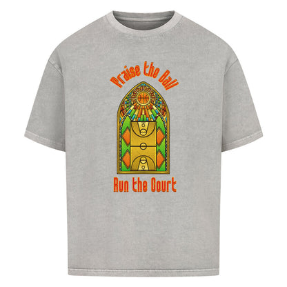 Washed Grey Oversized T-Shirt mit einem Print im Stil eines Kirchen-Buntglasfensters, der einen Basketball-Court zeigt. Darüber steht in Rot „Praise the Ball“ und darunter „Run the Court“. 100% Baumwolle.
