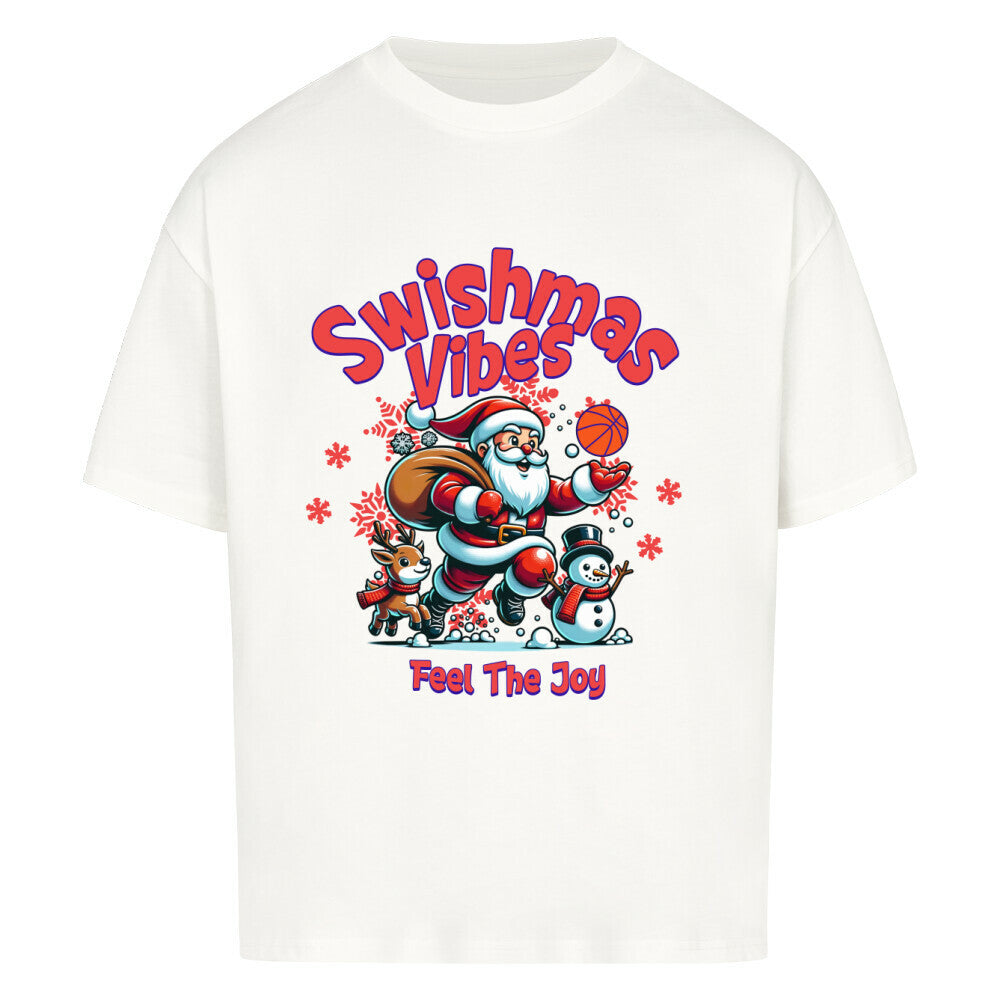 Oversized T-Shirt in Weiß mit dem Print "Swishmas Vibes Feel The Joy". Das Design zeigt einen fröhlichen Weihnachtsmann (Santa Claus), der einen Basketball in der Hand hält und von einem Rentier und einem Schneemann begleitet wird. Das T-Shirt ist aus 100% Baumwolle und hat einen weiten Schnitt.