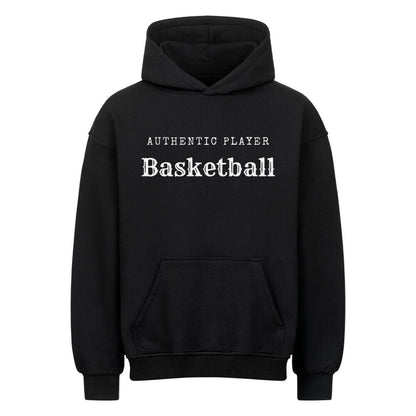 Vorderansicht eines schwarzen Oversized-Hoodies mit dem minimalistischen weißen Aufdruck 'Authentic Player Basketball' auf der Brust. Premium Baumwolle.