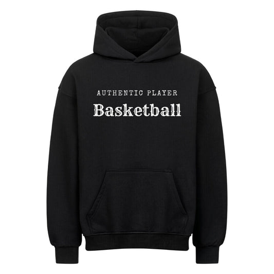 Vorderansicht eines schwarzen Oversized-Hoodies mit dem minimalistischen weißen Aufdruck 'Authentic Player Basketball' auf der Brust. Premium Baumwolle.