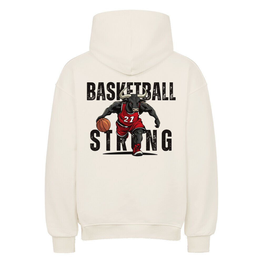 Rückansicht eines cremefarbenen Oversized-Hoodies mit 'Basketball Strong' Print, der einen Minotaurus im roten Trikot #21 beim Dribbling zeigt. Premium Baumwolle.