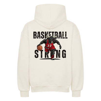 Rückansicht eines cremefarbenen Oversized-Hoodies mit 'Basketball Strong' Print, der einen Minotaurus im roten Trikot #21 beim Dribbling zeigt. Premium Baumwolle.