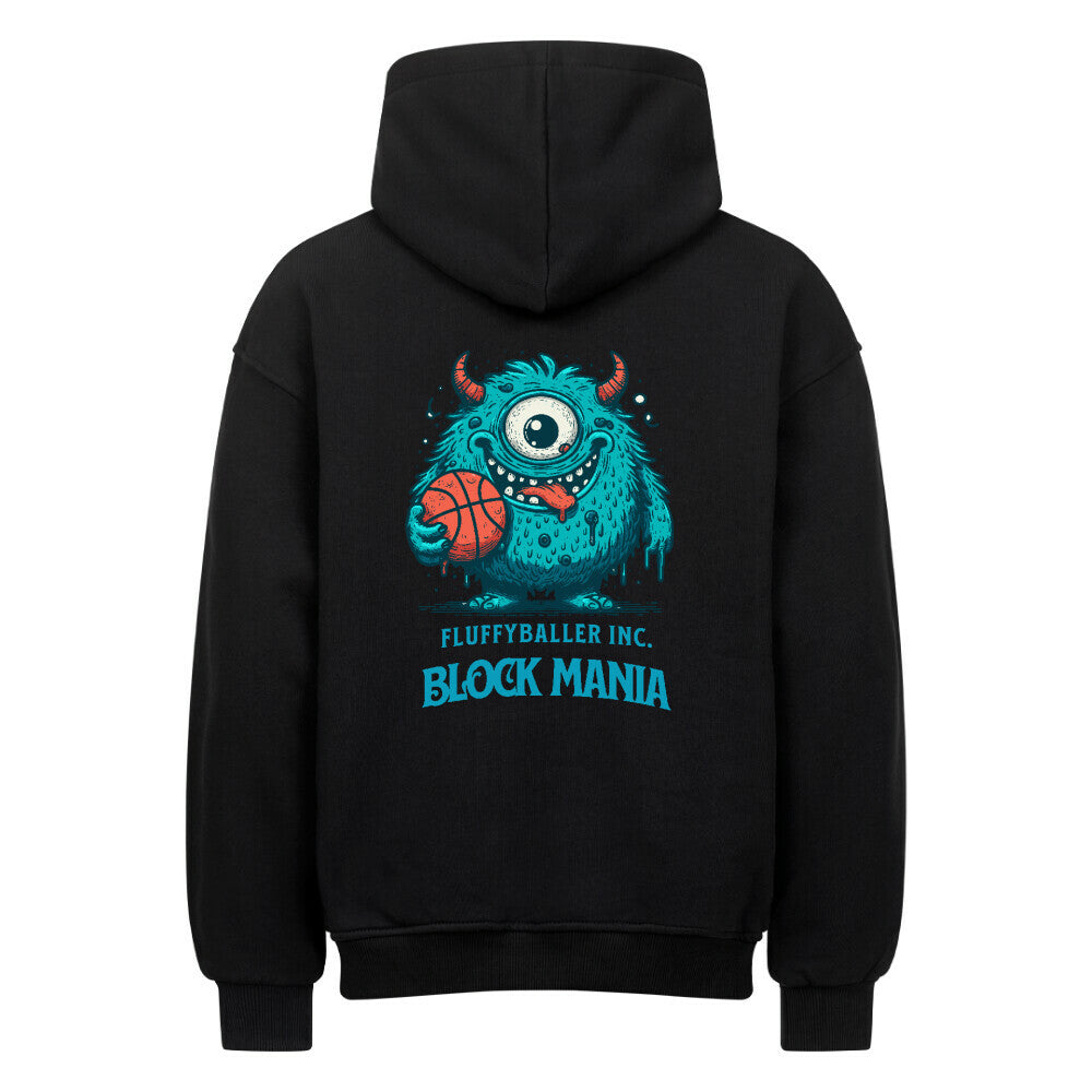 Rückansicht eines schwarzen Oversized-Hoodies mit 'Block Mania' Print, der ein türkises, einäugiges Monster zeigt, das einen Basketball hält.