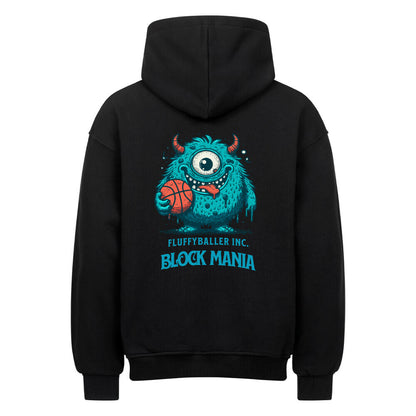 Rückansicht eines schwarzen Oversized-Hoodies mit 'Block Mania' Print, der ein türkises, einäugiges Monster zeigt, das einen Basketball hält.