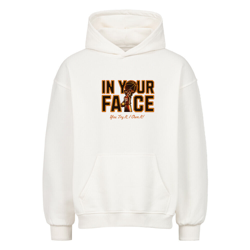 Vorderansicht eines weißen Oversized-Hoodies mit 'In Your Face' Print, der einen Basketballspieler und den Spruch 'You Try It, I Own It!' zeigt.